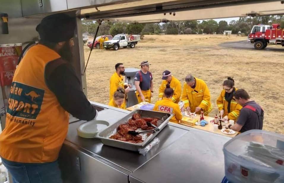 Sikh volunteers serving food to relief workers.  