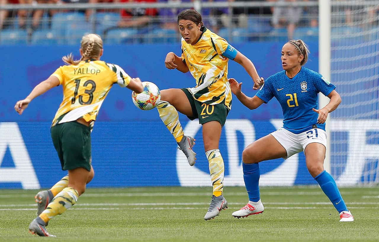 Monica (R) of Brazil in action against Sam Kerr of Australia during the preliminary round match between Brazil and Australia.
