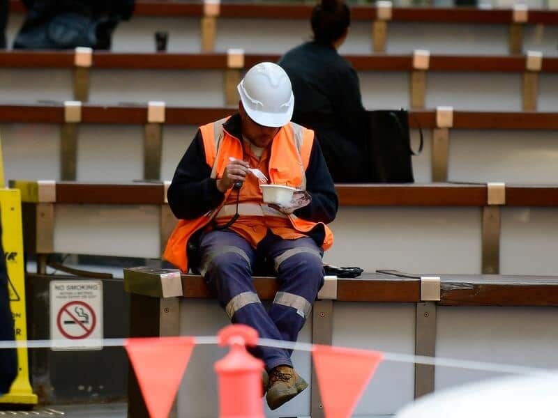 A construction worker eating a meal.