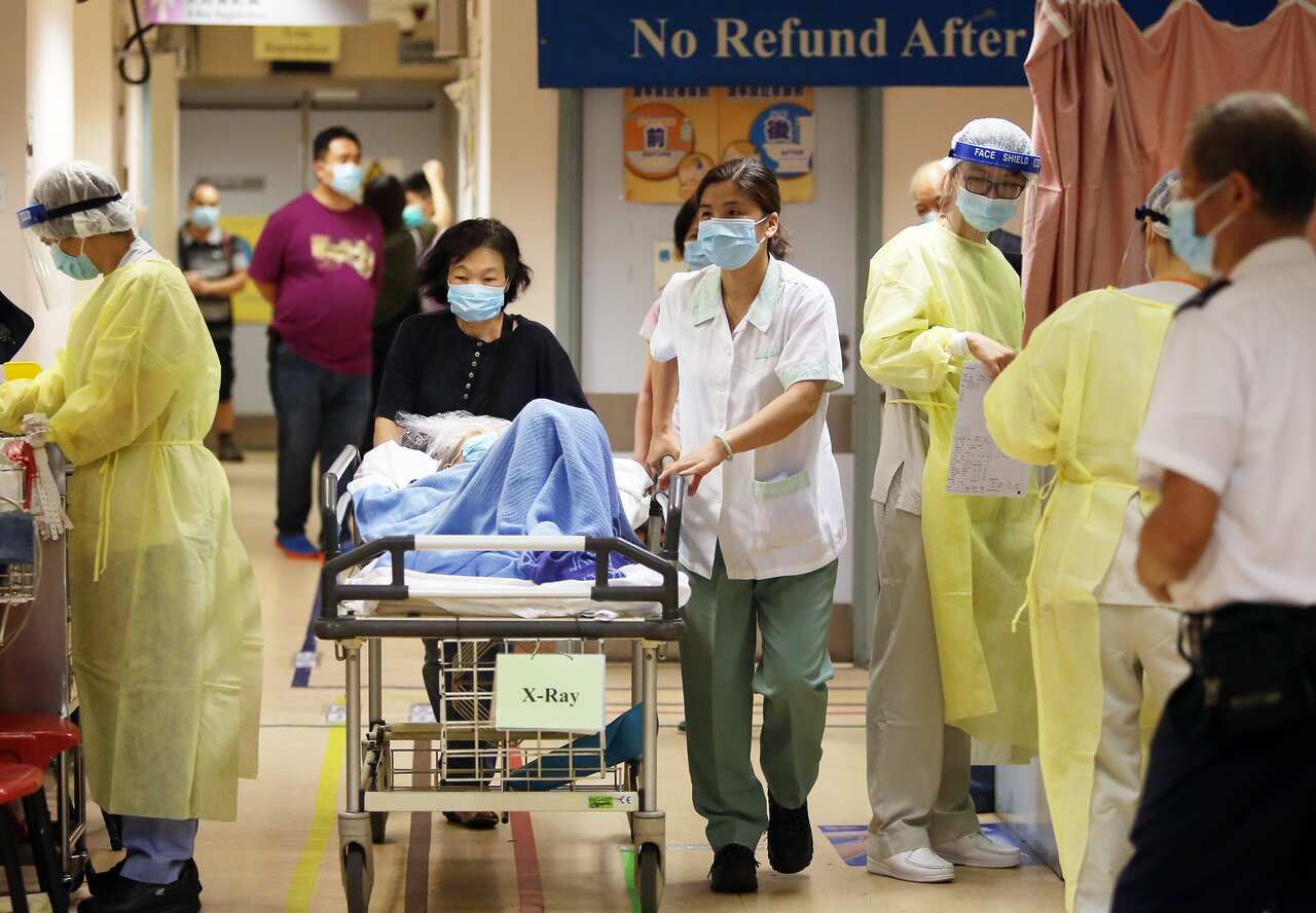 Medical staff in protective outfits take precautions with patients at Kwong Wah Hospital in Yau Ma Tei.