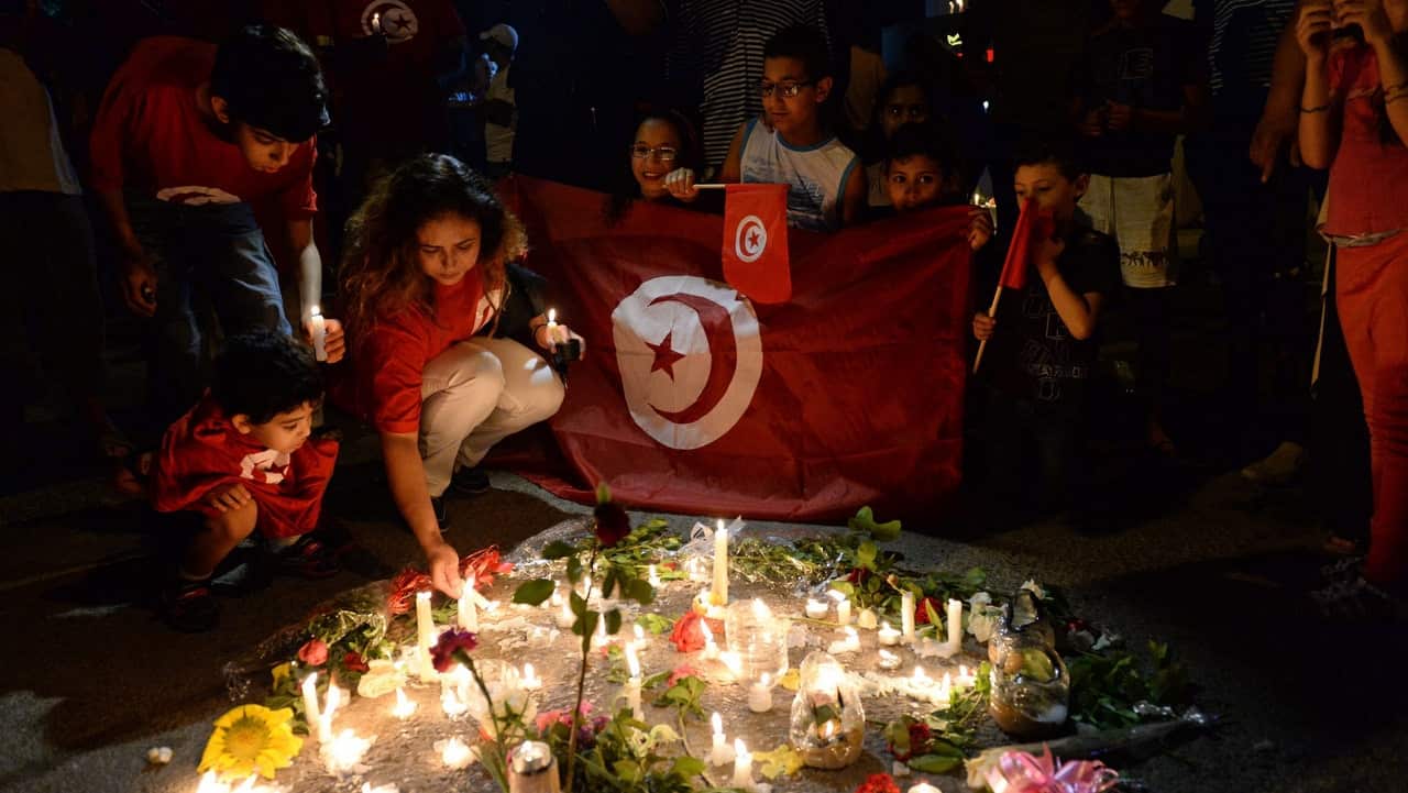 Demonstrators gather around a tribute for the victims of a terrorist attack, during a rally in front of the Hotel Imperial Marhaba in Sousse.