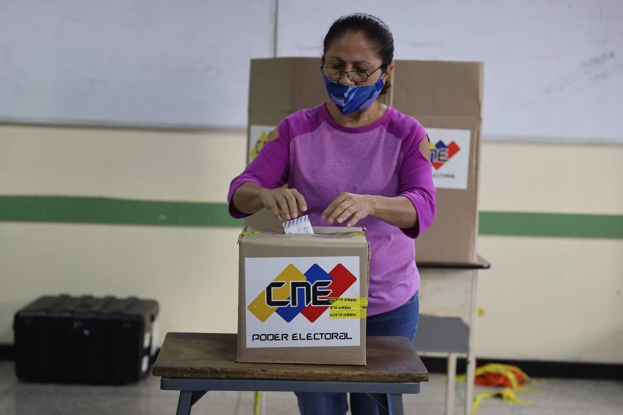 A woman casts her vote at a poll station in Caracas, Venezuela.