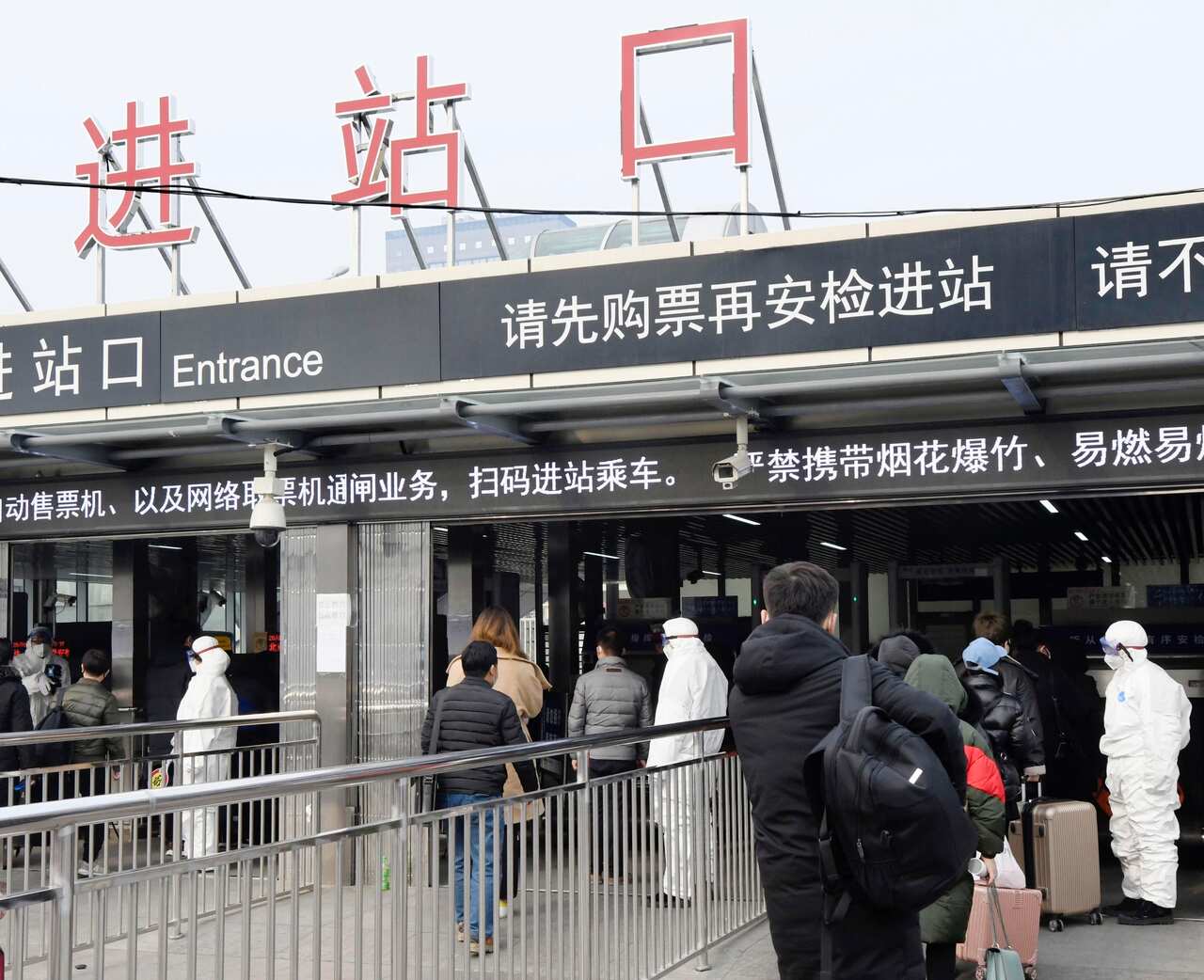 Passengers' body temperatures are checked at a subway station in Beijing on Jan. 26, 2020, amid the spread of pneumonia caused by a new coronavirus in the central Chinese city of Wuhan. (Kyodo via AP Images) ==Kyodo