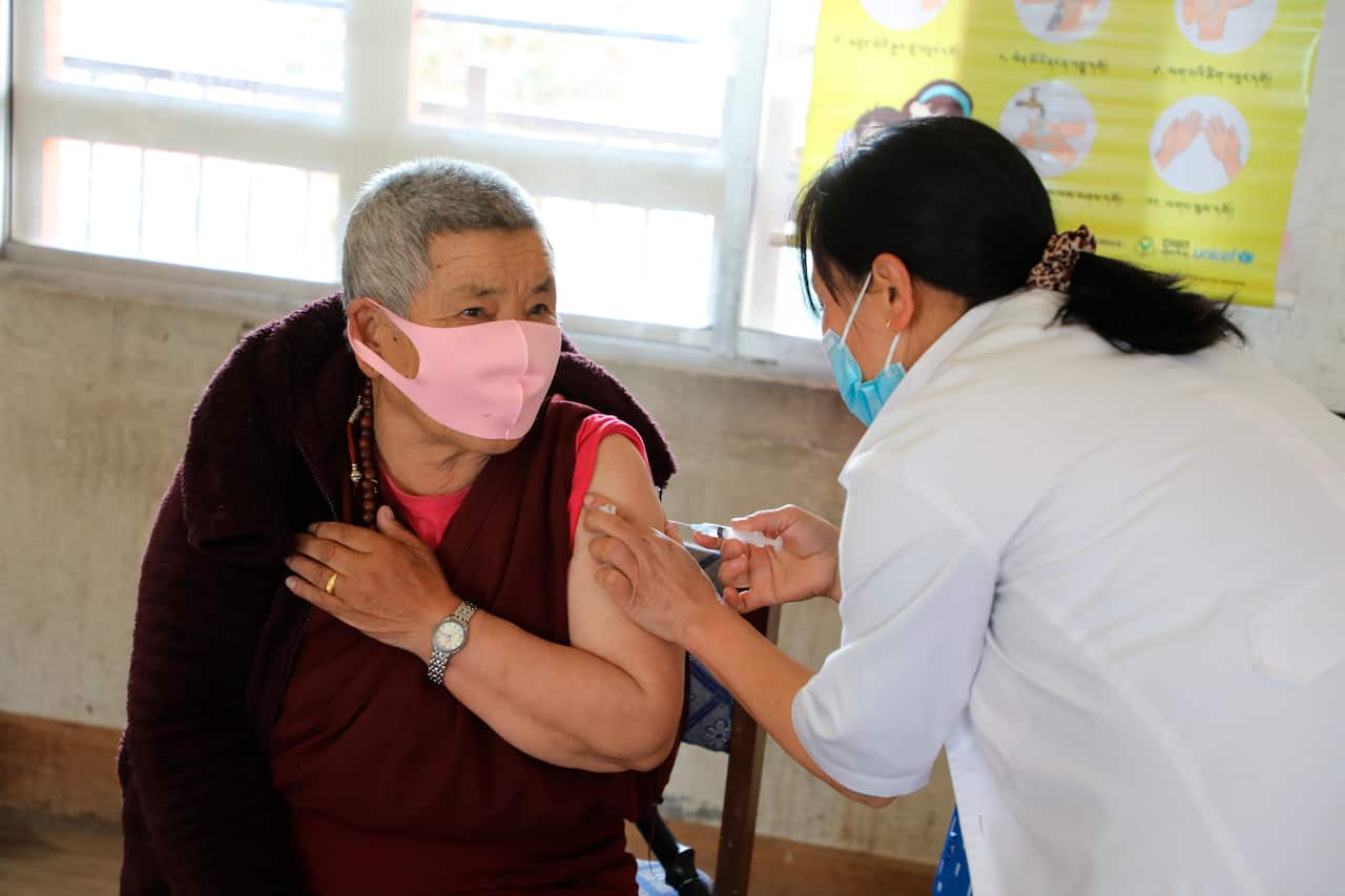 A health worker administers COVID-19 vaccine to a man at a health centre in Thimpu, Bhutan, Sunday, March 28, 2021
