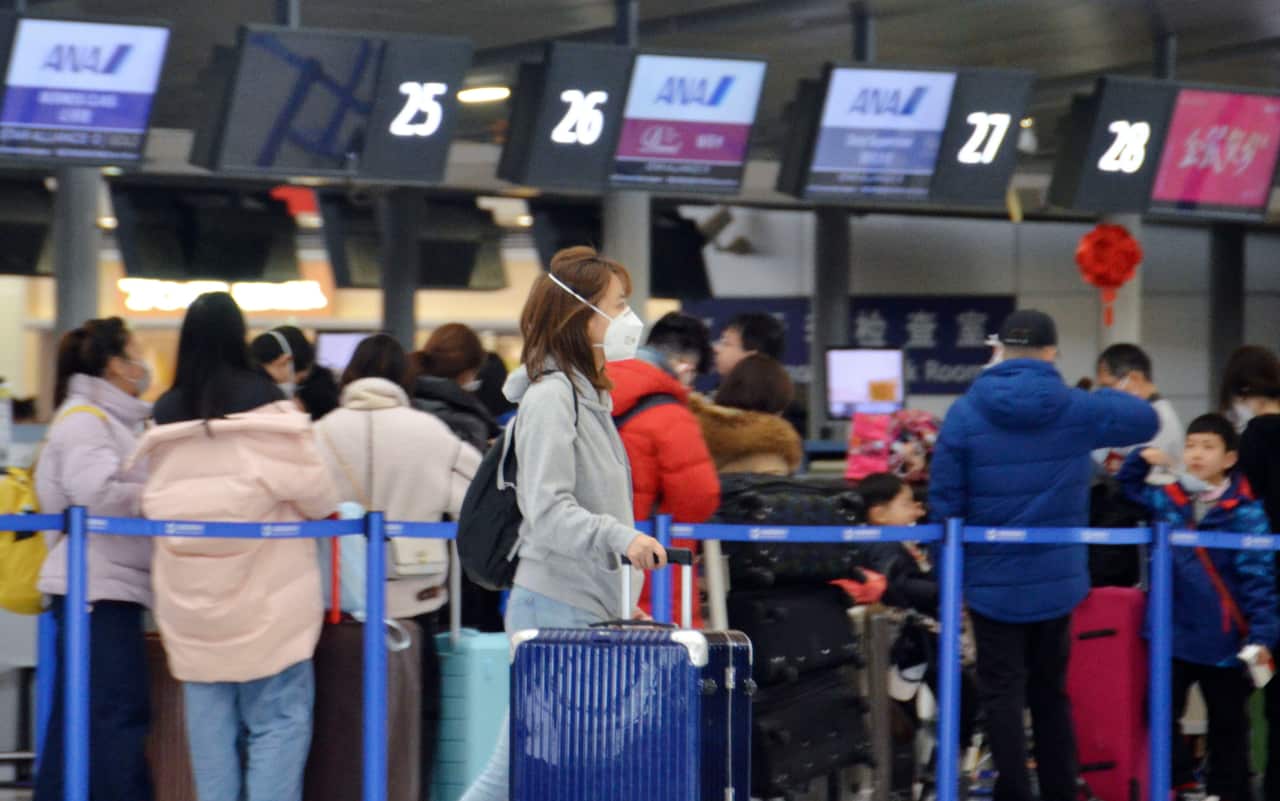 A woman wears a mask at Shanghai Pudong International Airport on Jan. 26, 2020, amid the spread of pneumonia caused by a new coronavirus in the central Chinese city of Wuhan. (Kyodo via AP Images) ==Kyodo