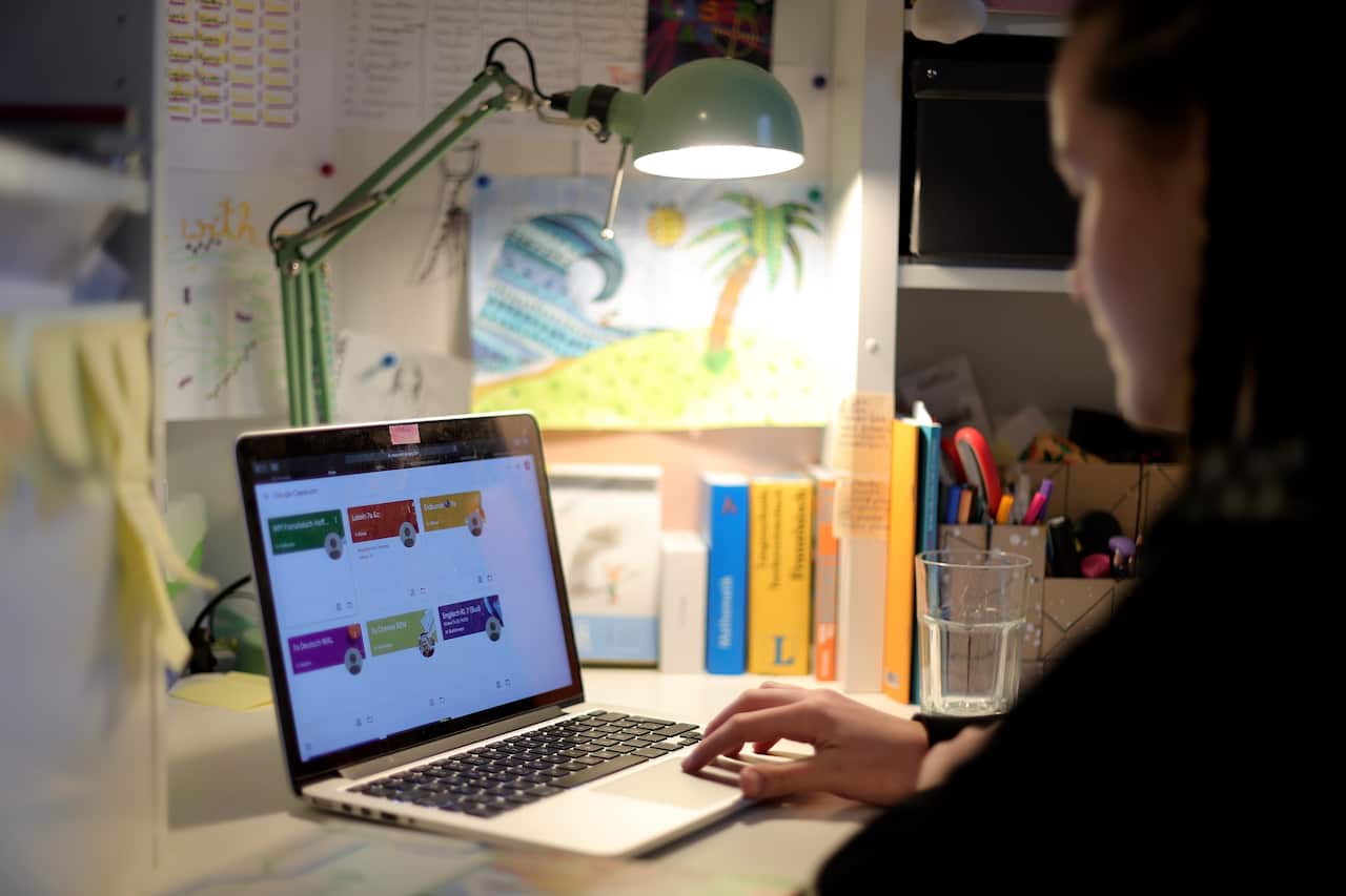 A girl in secondary school does her homework, which was received via the App Google Classroom, in her home in Dortmund, Germany. 