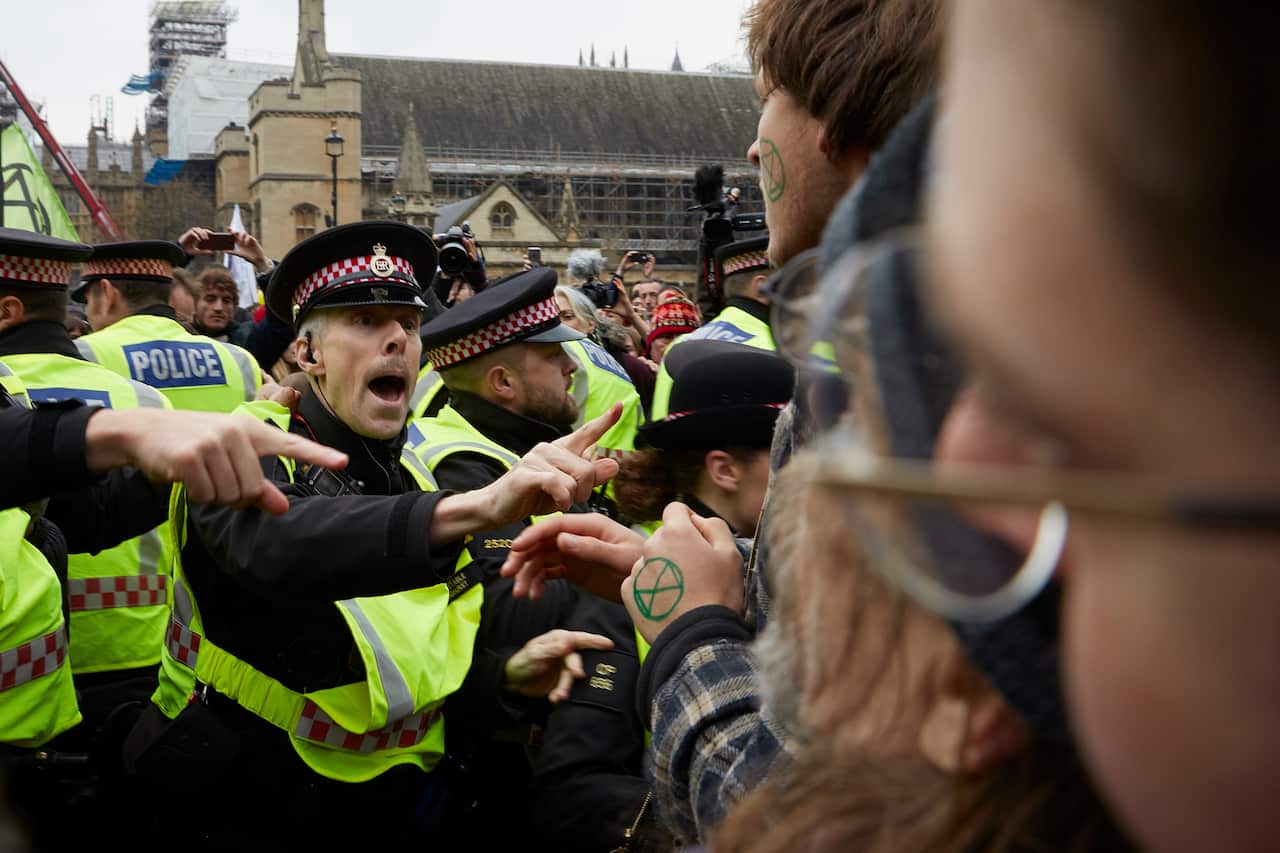 Activists clash with police during a climate change protest in Westminster.