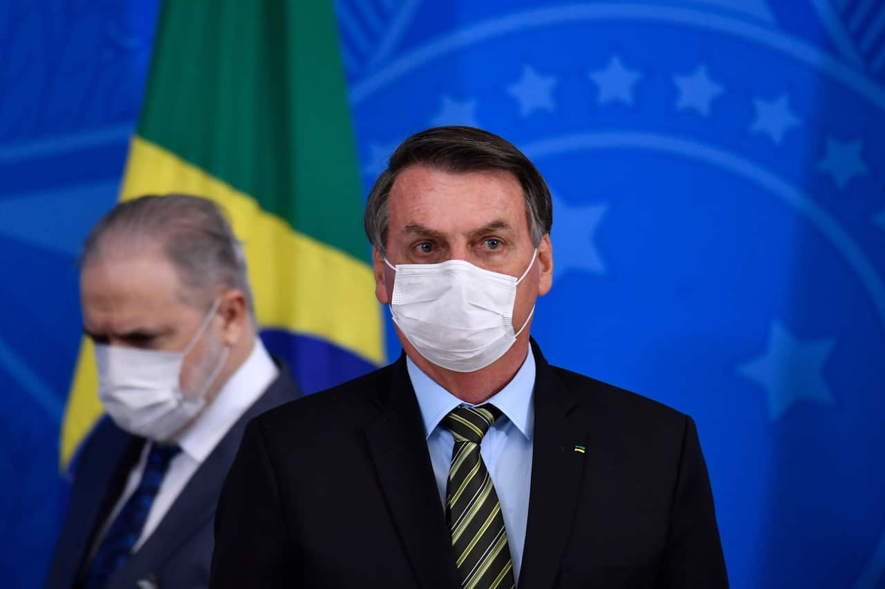 Brazil's President Jair Bolsonaro and Attorney General of the Republic Augusto Aras wearing protective masks.