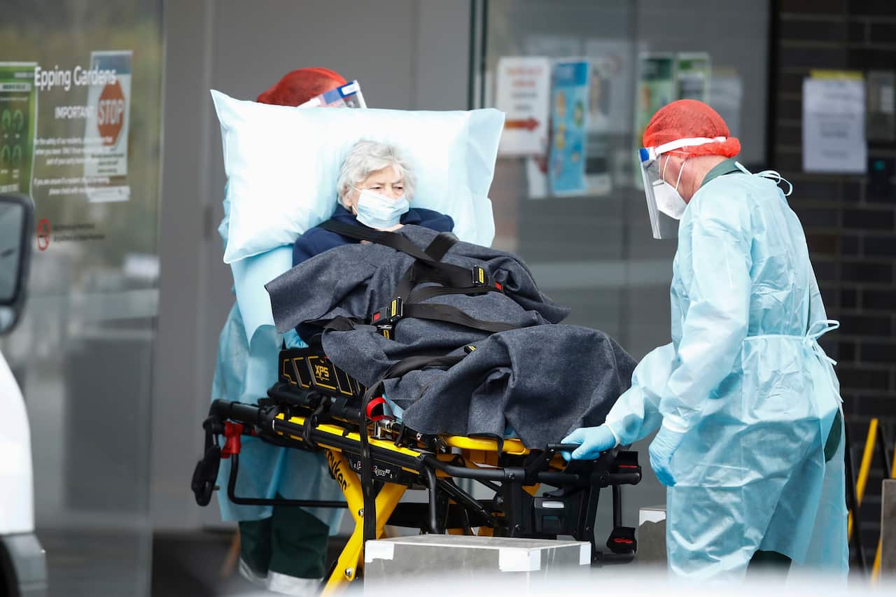 A resident is taken away in an ambulance from Epping Gardens Aged Care Facility in Epping, Melbourne, Tuesday, July 28, 2020.