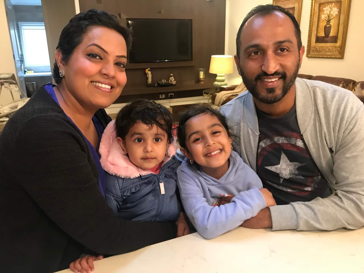 Inderdeep and Harpreet Sandhu with their two children.  