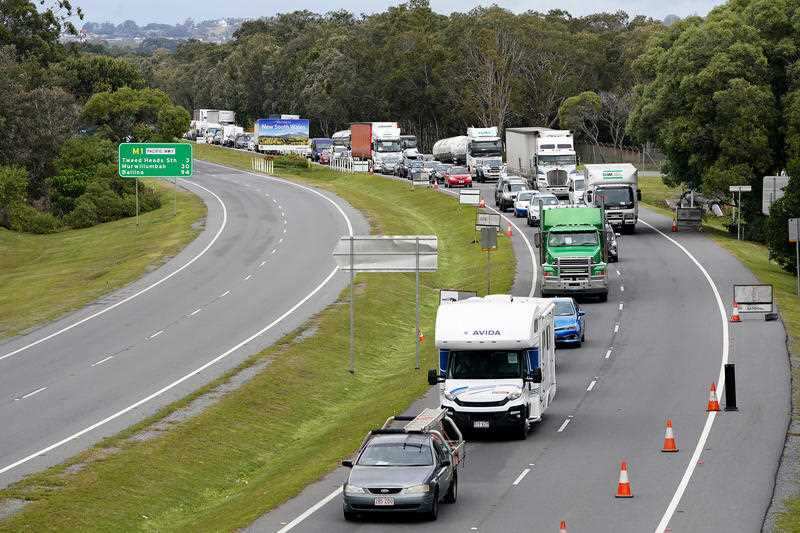 Motorists are seen approaching a checkpoint at Coolangatta on the Queensland- New South Wales border.