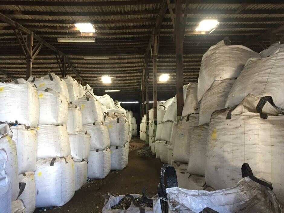 Inside Polytrade's warehouses, there are rows upon rows of giant bags storing unused glass.