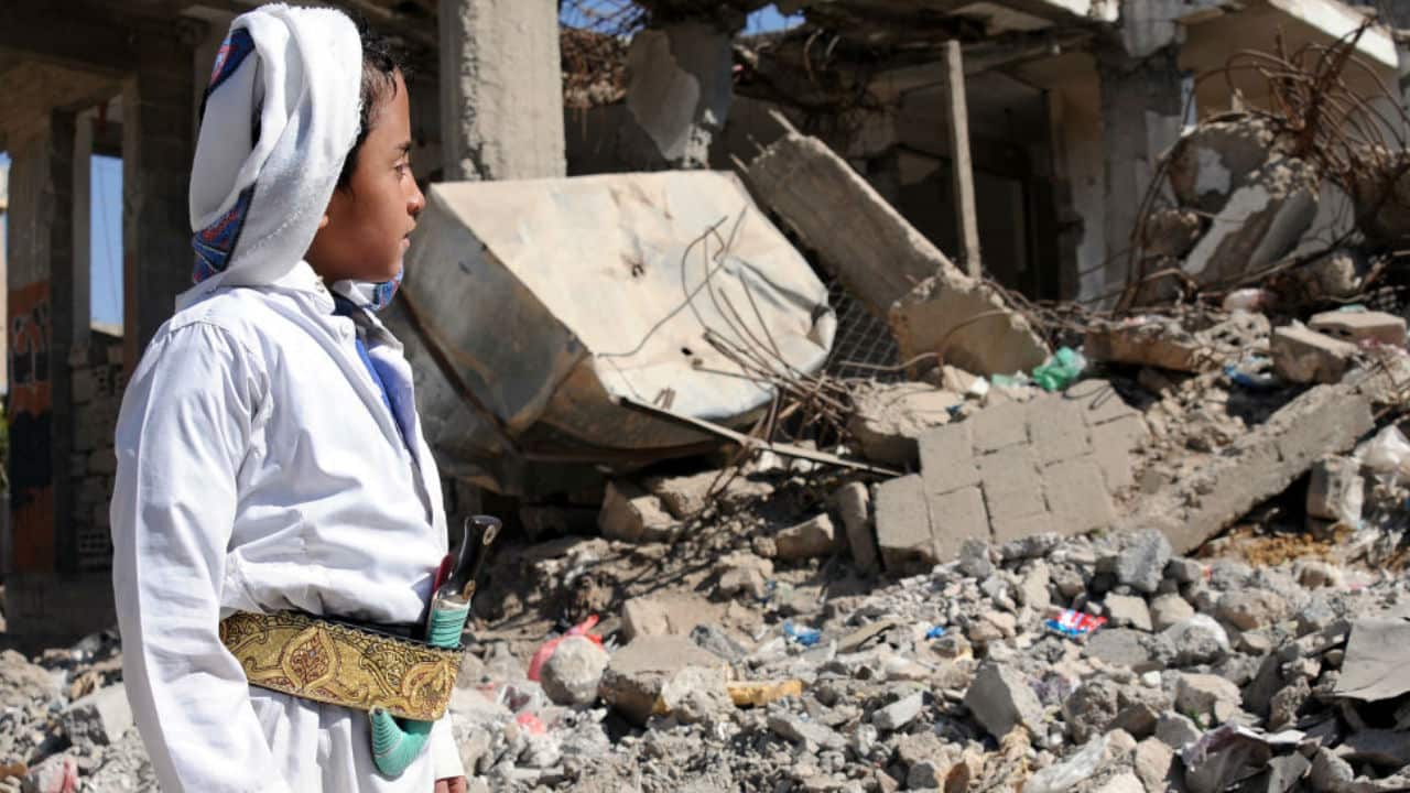 A boy looks at a house destroyed by a past airstrike carried out by a war-plane of the Saudi-led coalition in Sana’a, Yemen.