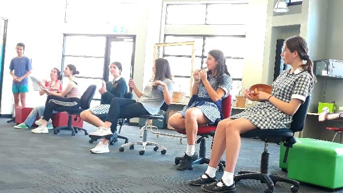 At the play rehearsals. 