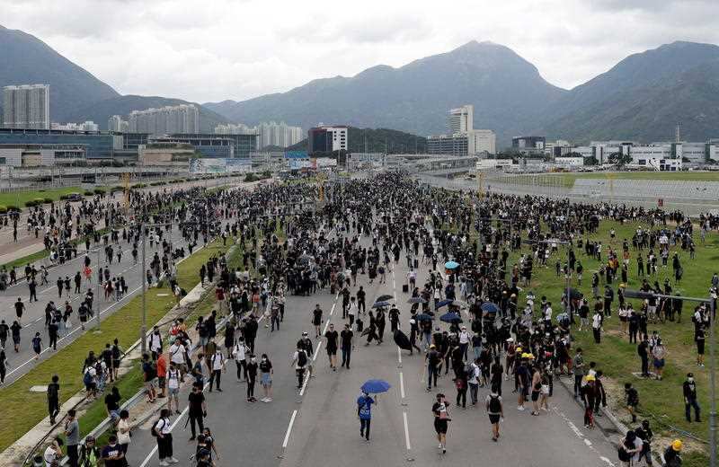 Protesters block a road leading to the Hong Kong International Airport in Hong Kong