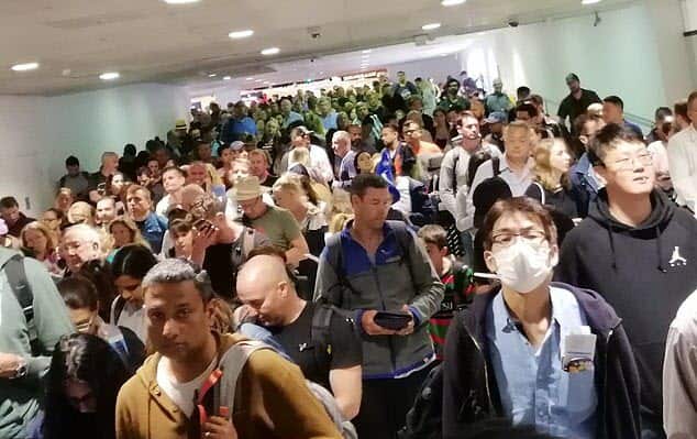 Passengers queue at Melbourne Airport.