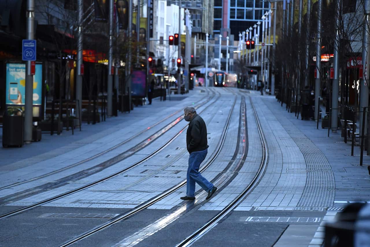 A pedestrian walks along George St in the central business district in Sydney, 20 July 2021.