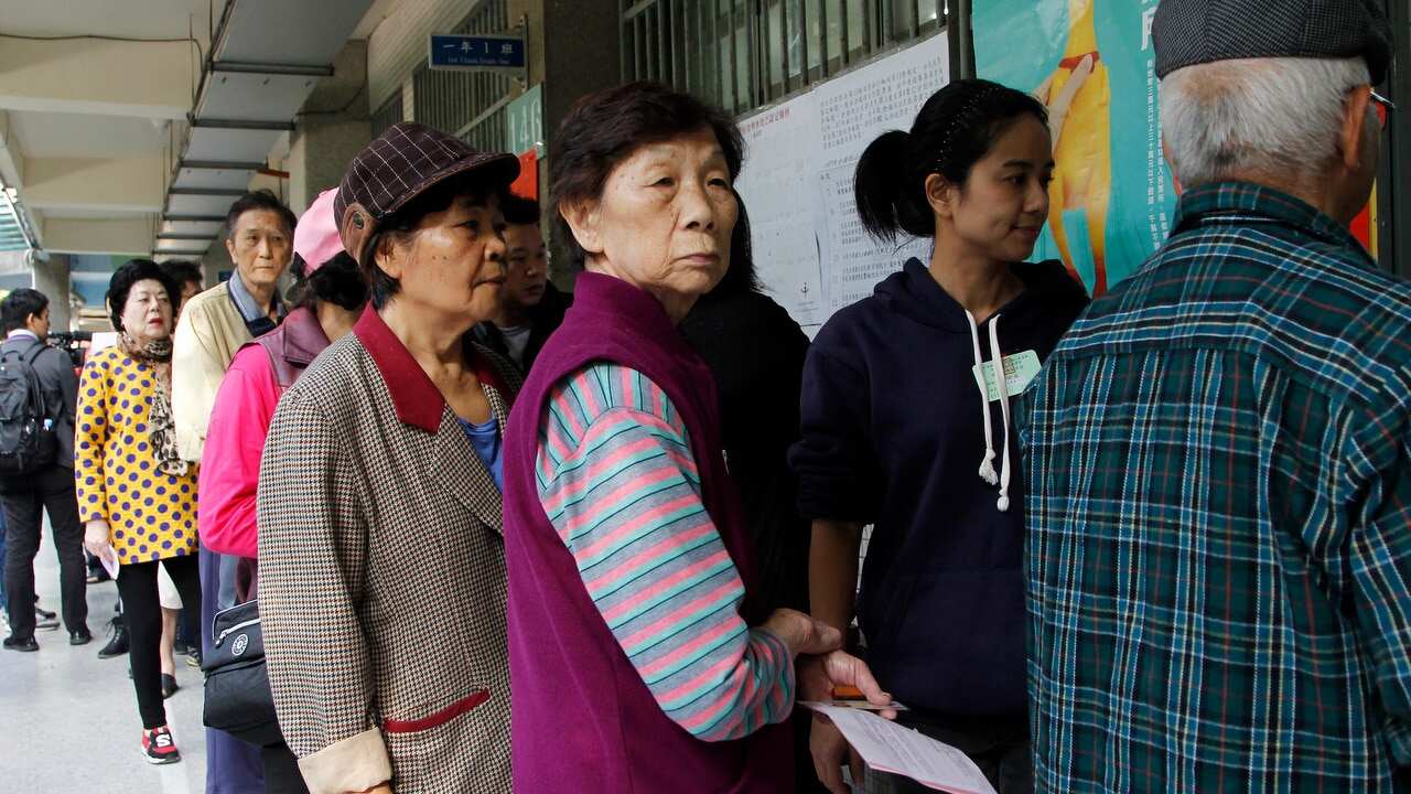 Taiwanese line up to cast their ballots at a polling station.