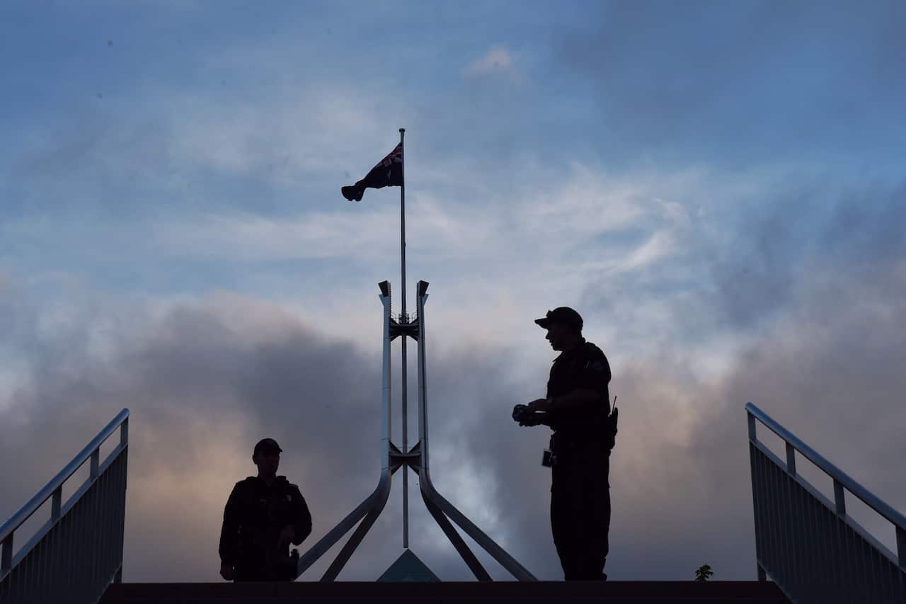 Armed Australian Federal Police officers are seen after new security directives are instigated at Parliament House in Canberra, Monday, Feb. 23, 2015. (AAP Image/Mick Tsikas) NO ARCHIVING