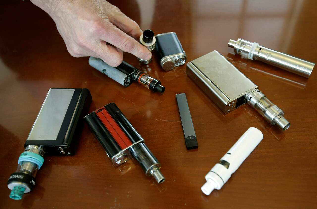 A high school principal displays vaping devices that were confiscated from students in restrooms or hallways 