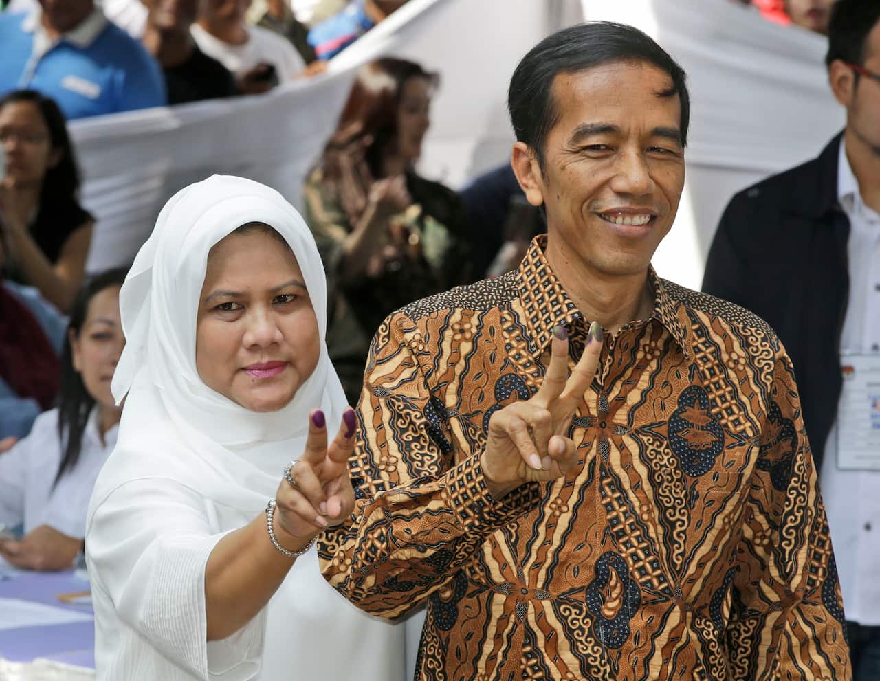 Indonesian presidential candidate Joko Widodo, popularly known as "Jokowi", left, and his wife Iriana.