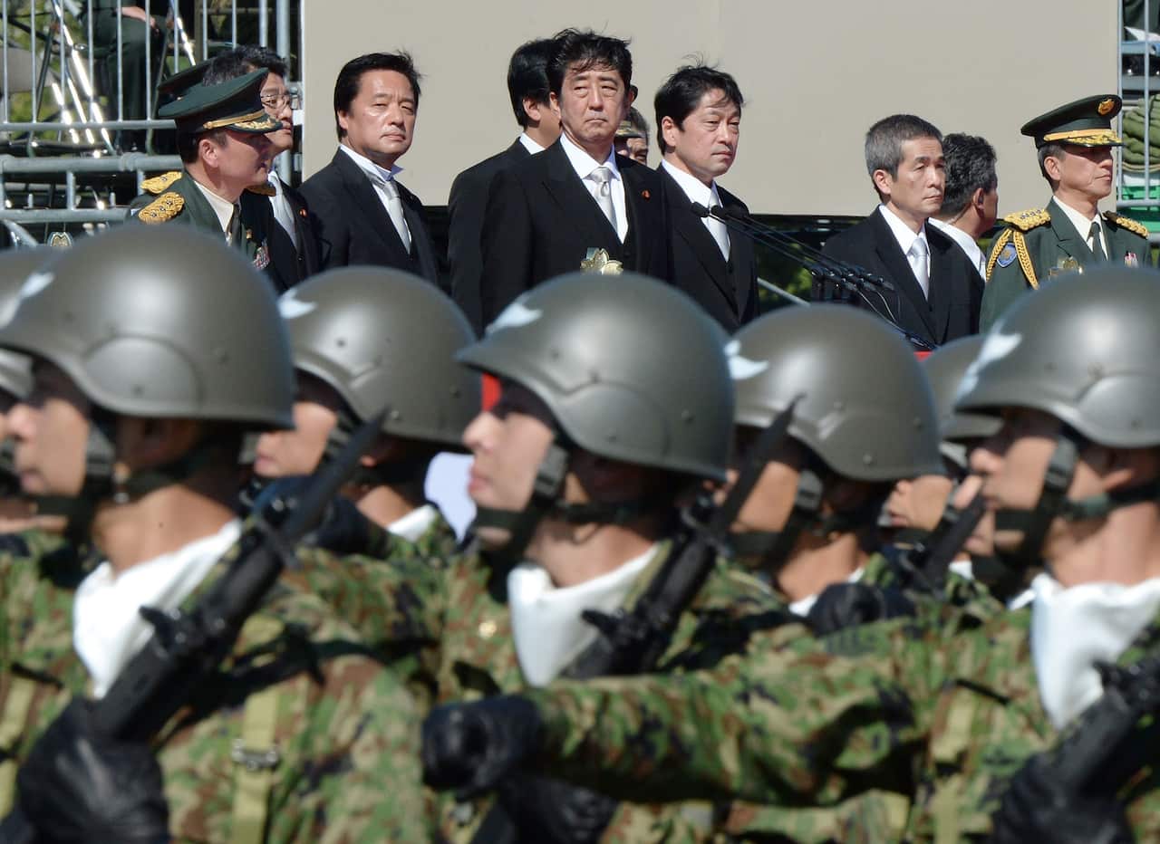 Japanese Prime Minister Shinzo Abe (top C) inspecting troops of Japan's Self-Defence Force