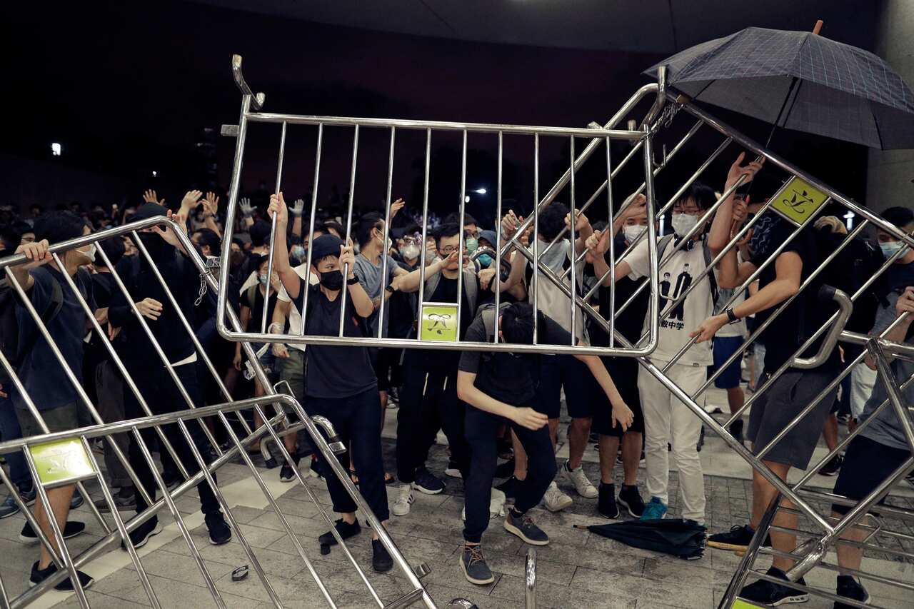 Protesters use barriers against the proposed amendments to the extradition law at the Legislative Council in Hong Kong