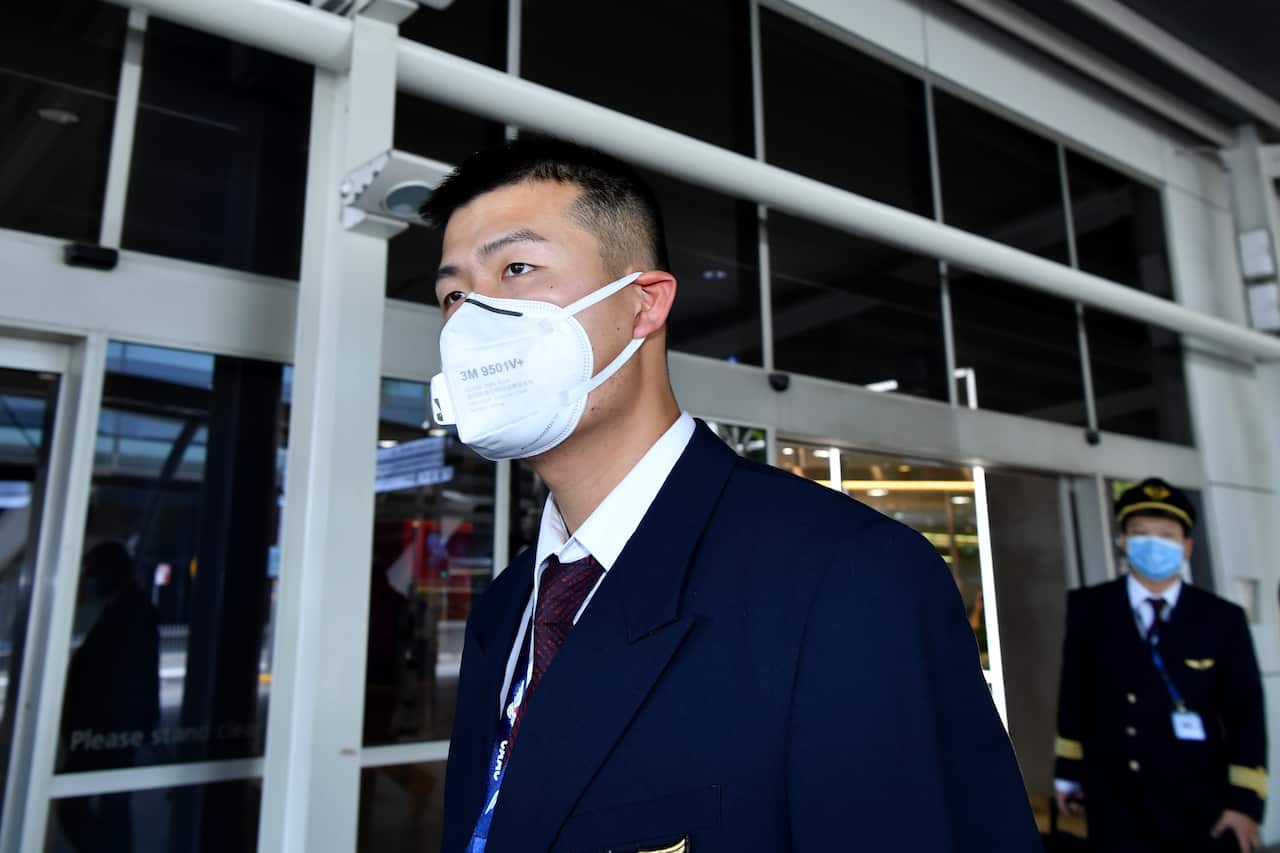 China Eastern Airlines flight crew wear protective masks on arrival at Sydney International Airport. 