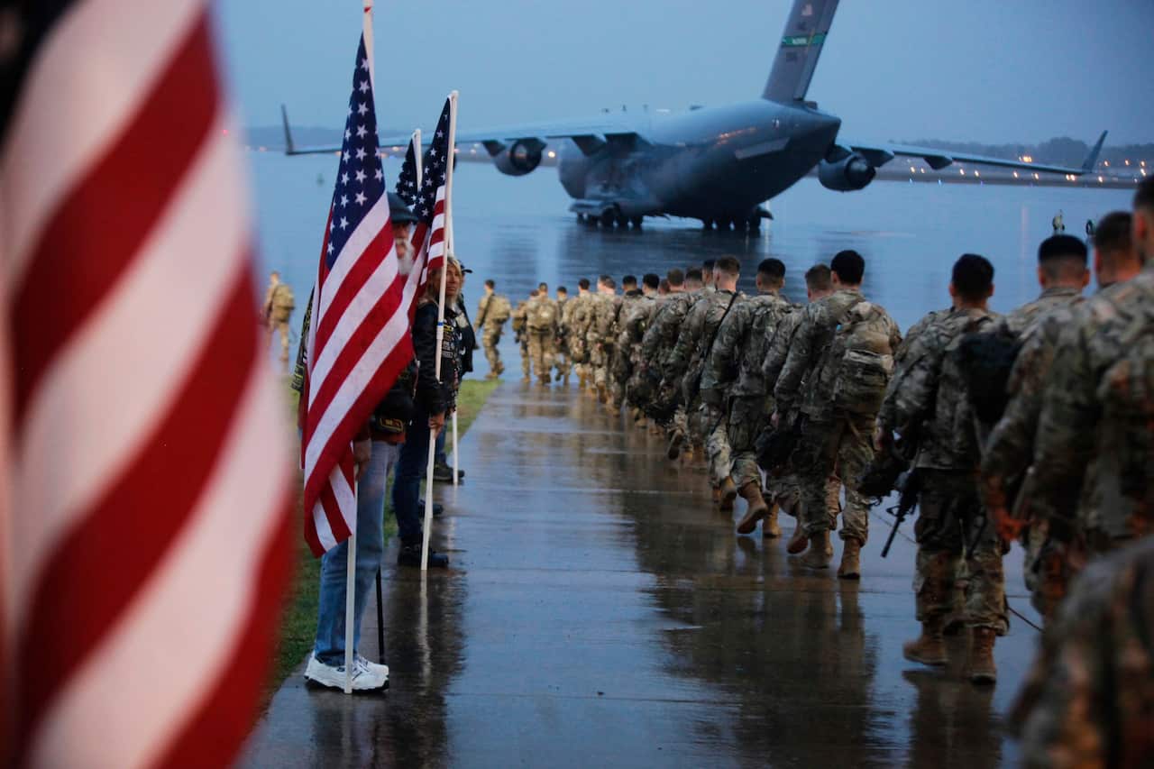 Paratroopers from the 82nd Airborne Division prepare equipment and load aircraft bound for Fort Bragg, ahead of deployment to Iraq.
