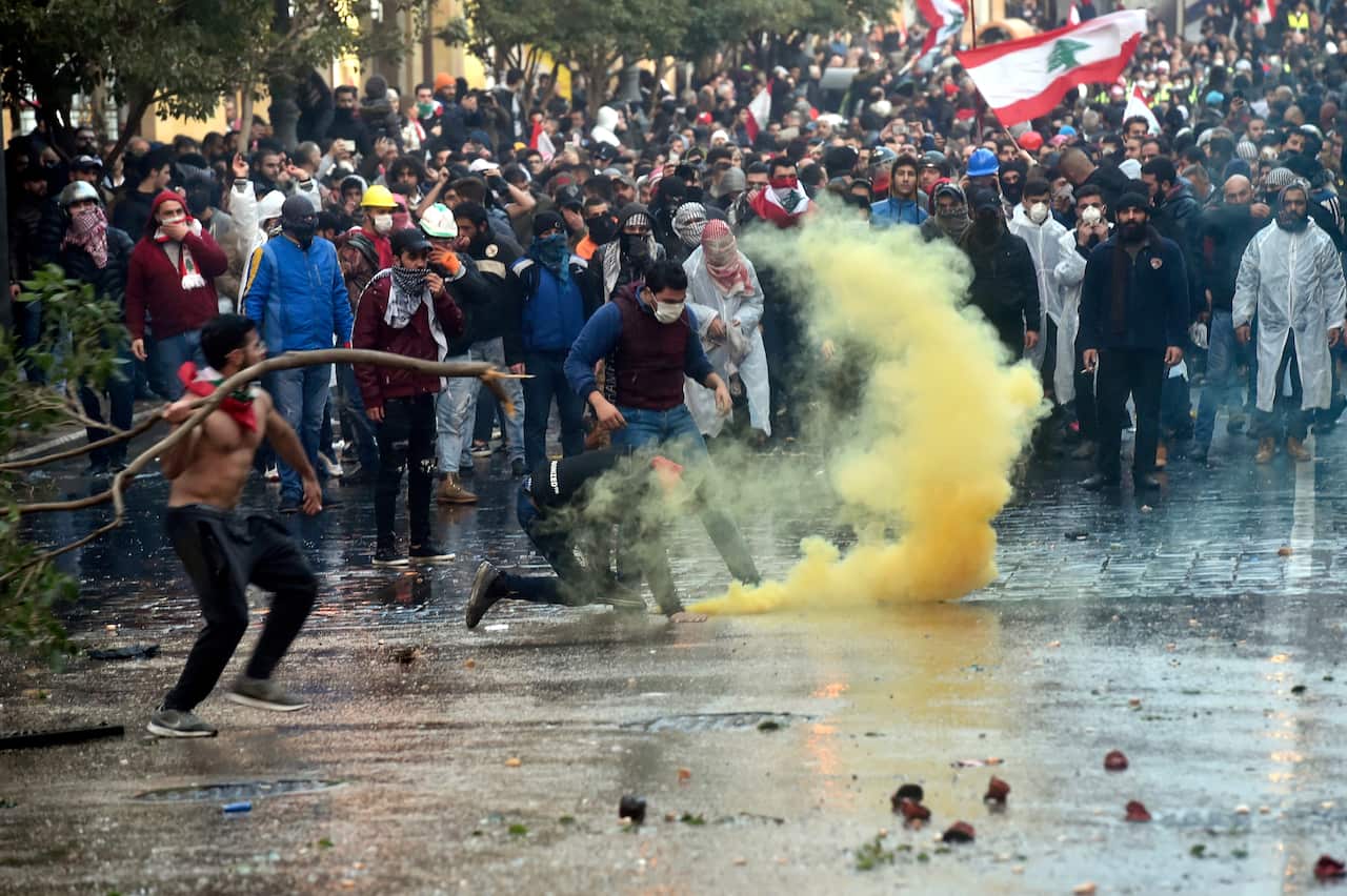 Anti-government protesters clash with Lebanese riot police during a protest outside of the Lebanese Parliament in downtown Beirut.