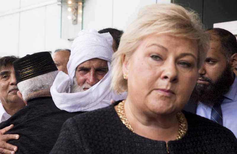 Norway's Prime Minister (front) stands outside Thon Hotel in Baerum, Norway