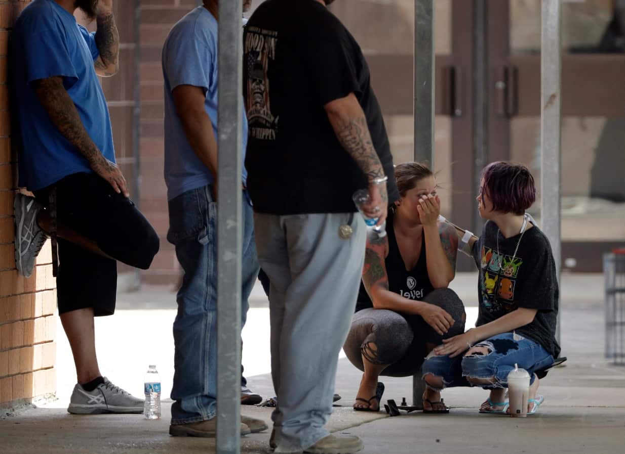People react outside the unification center at the Alamo Gym, following a shooting at Santa Fe High School Friday, May 18, 2018, in Santa Fe, Texas.