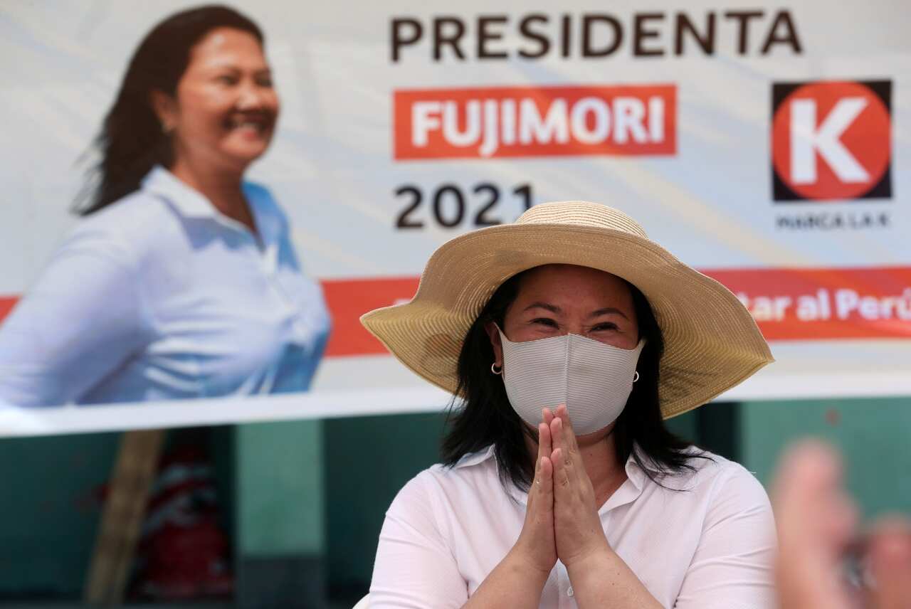 In this 24 March, 2021 file photo, presidential candidate Keiko Fujimori waves to supporters as she campaigns on the outskirts of Lima, Peru.
