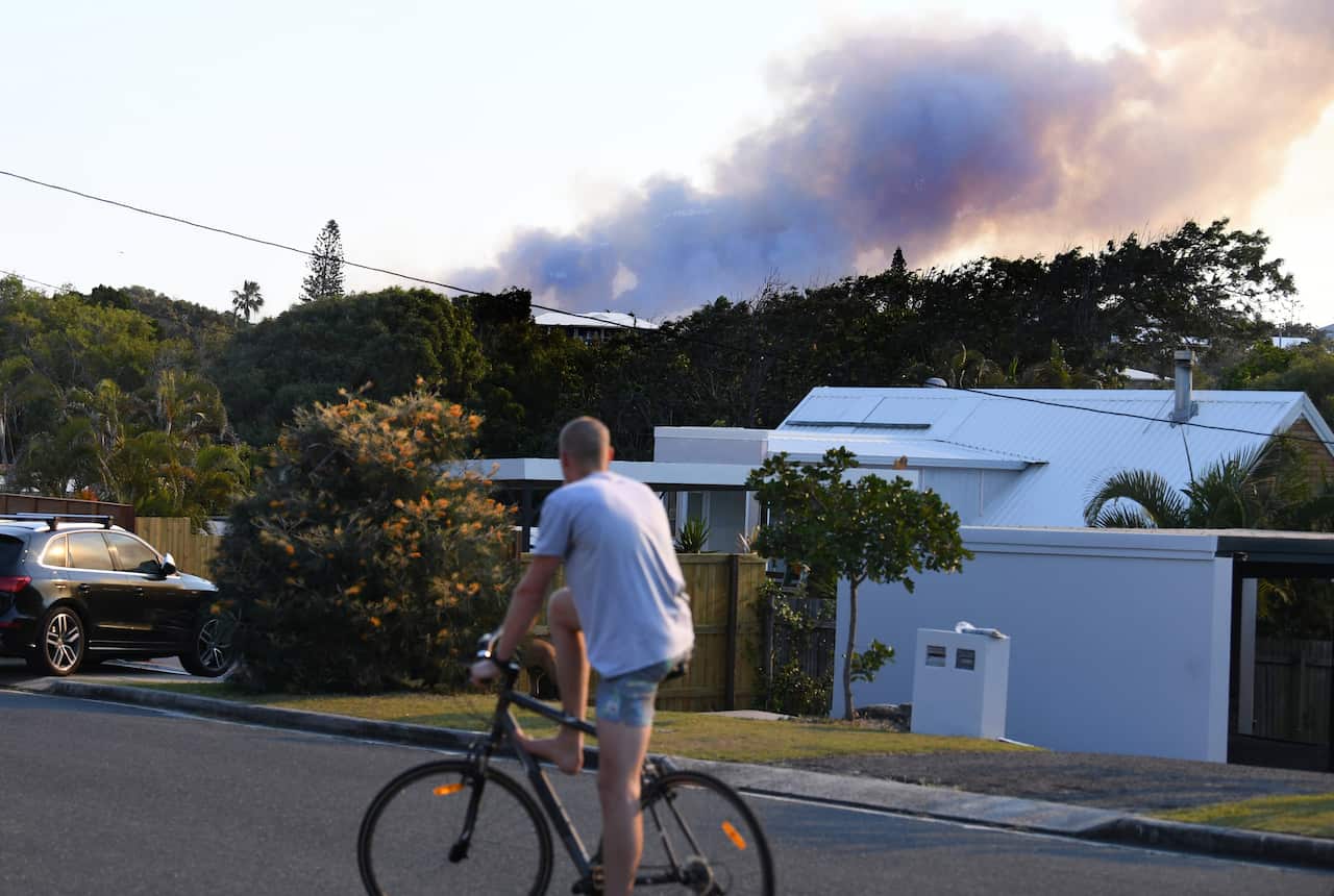 Dark smoke billows from a bushfire near Peregian Beach on the Sunshine Coast.