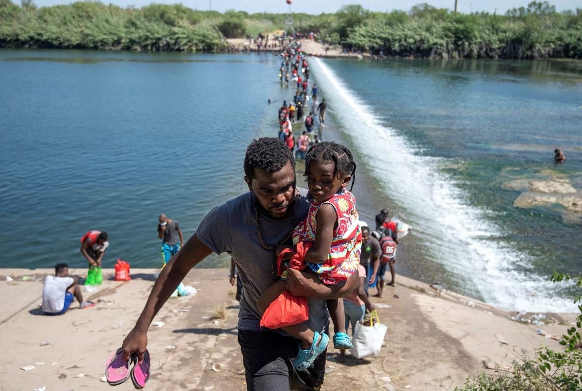 Migrants wait on the Rio Grande to cross to the United States, in Ciudad Acuna, Coahuila state, Mexico, 18 September 2021.