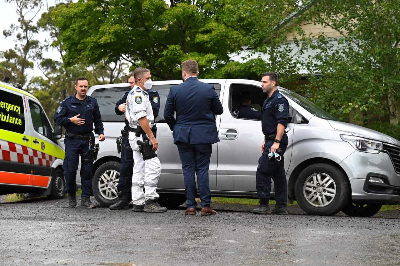 Police speak with each other at a mobile command post in Mount Wilson, north of Katoomba, NSW, Tuesday, 18 January, 2022. 