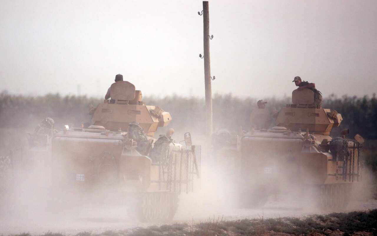Turkish armored vehicles cross over into northern Syria as part of the attack. 