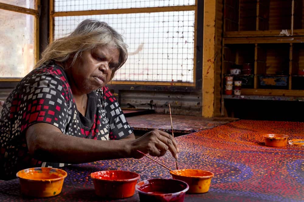 Nyunmiti Burton paints at the Tjala Arts Centre. 