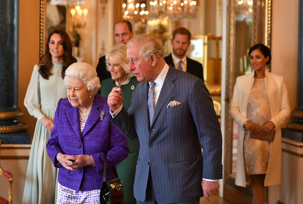 Britain's Queen Elizabeth is joined by Prince Charles, Kate, Camilla, Prince William, Prince Harry and Meghan, Duchess of Sussex during a reception at Buckingham Palace, London.