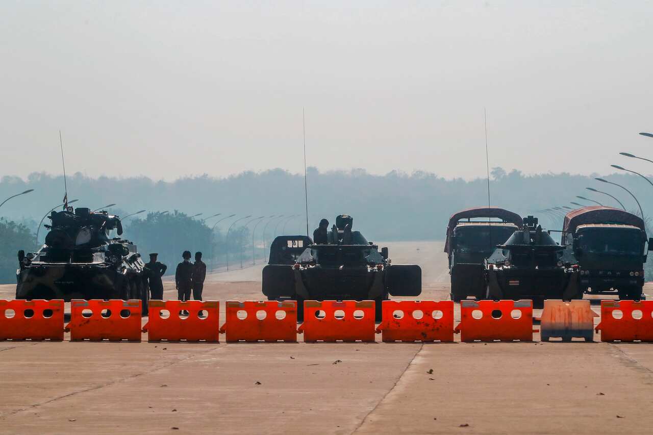 Myanmar's military stand guard at a checkpoint manned with an armored vehicles blocking a road leading to the parliament building on 2 February, 2021.
