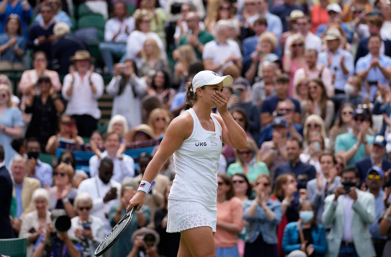 Australia's Ashleigh Barty celebrates after defeating Germany's Angelique Kerber during the women's singles semifinals match on day ten of the Wimbledon Tennis Championships in London, Thursday, July 8, 2021. (AP Photo/Kirsty Wigglesworth)
