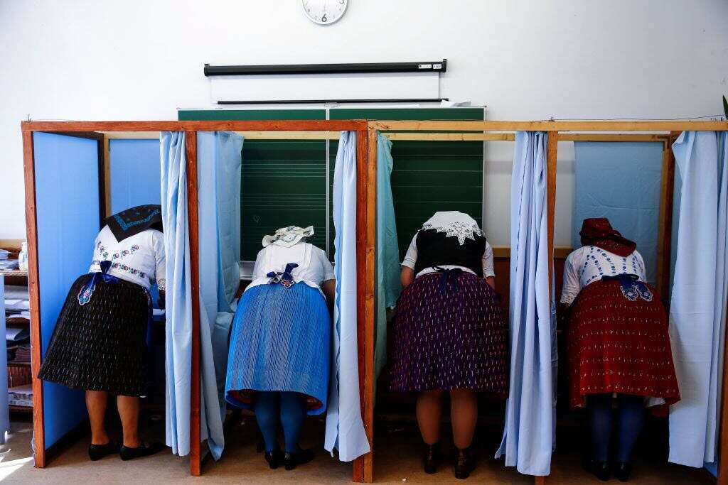 People, dressed in traditional clothes, cast their votes during Hungarian parliamentary election at a polling station in Veresegyhaz, Hungary on April 08, 2018. 