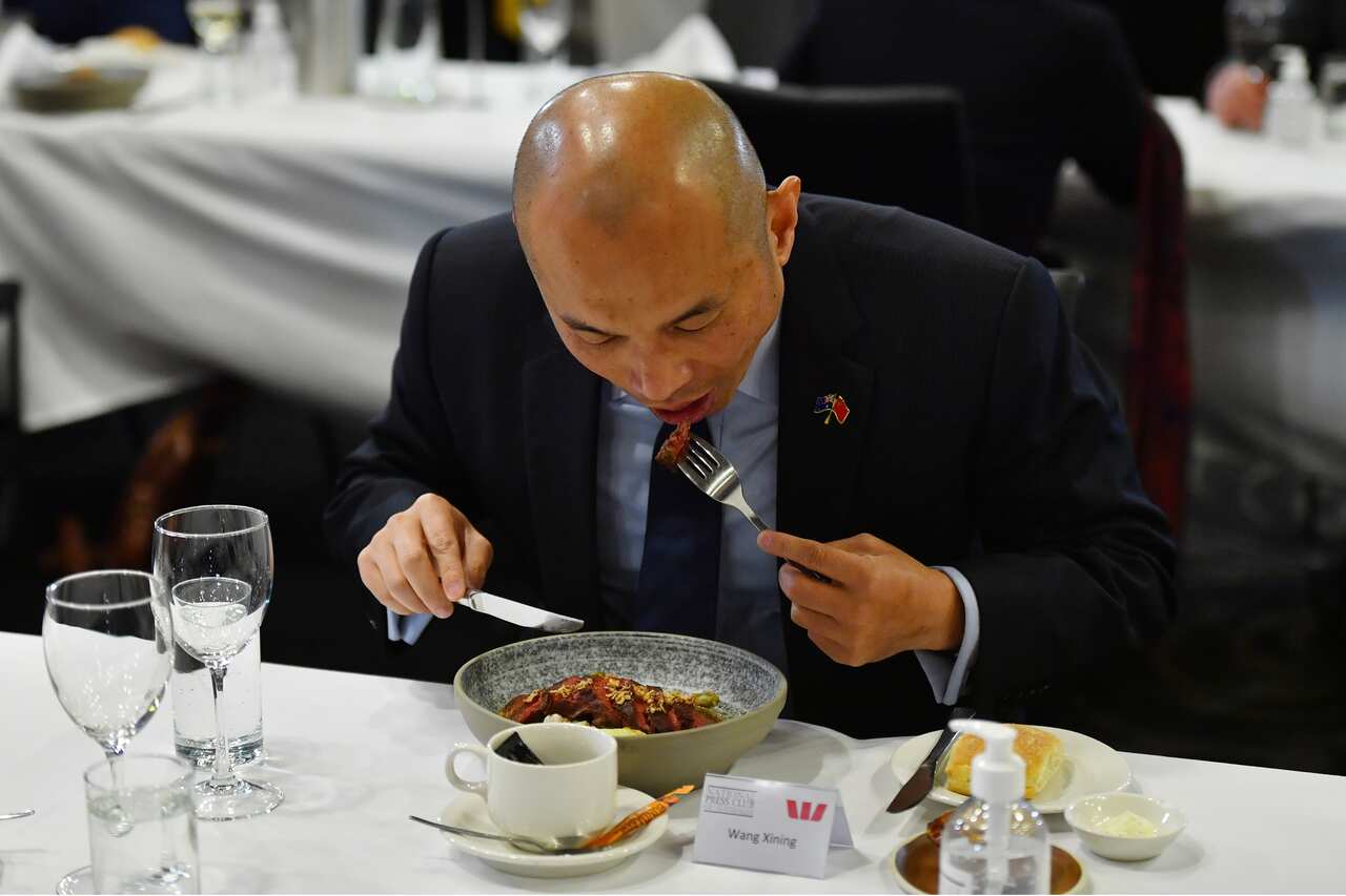 Deputy Head of Mission of the Chinese Embassy in Australia Wang Xining eats the beef at the National Press Club in Canberra.