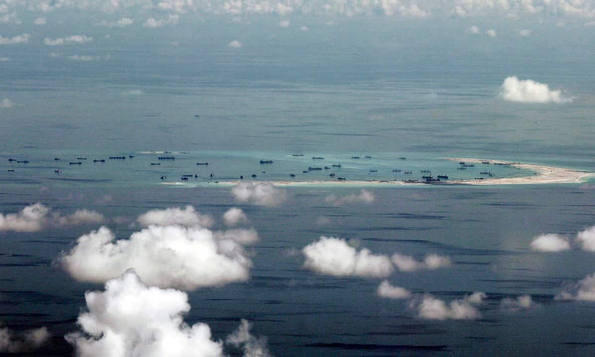 American officials say two US Navy warships have sailed near South China Sea islands.