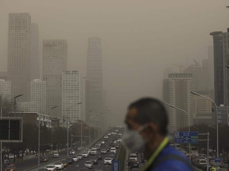 A man wearing a face mask walks in Beijing