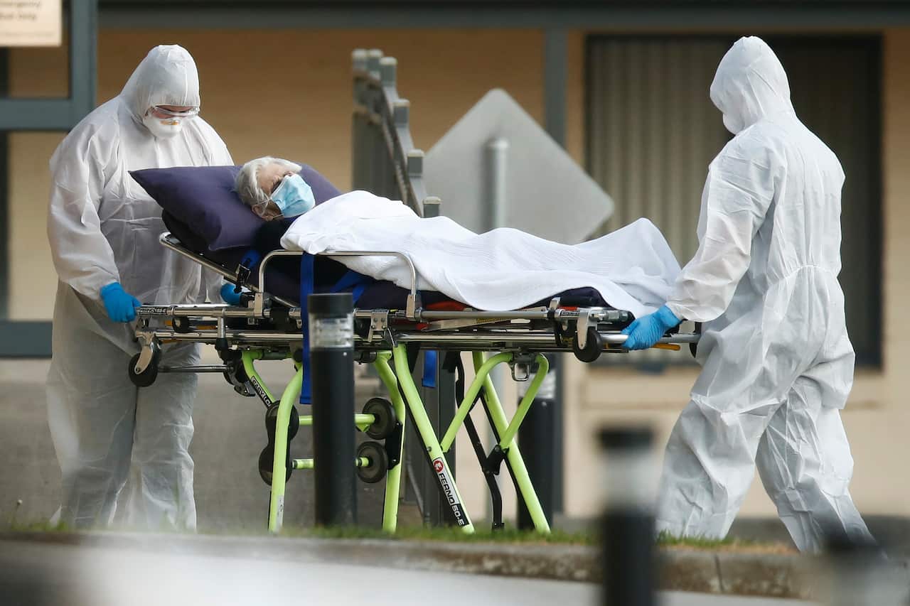 A resident is removed from St Basil’s Homes for the Aged in Fawkner, Melbourne, Friday, July 31, 2020. (AAP Image/Daniel Pockett) NO ARCHIVING