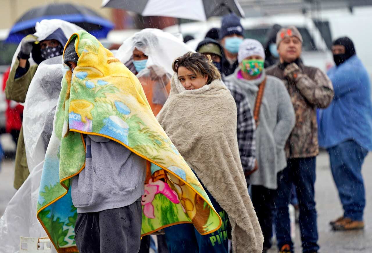 People wait in line to fill propane tanks Wednesday, February 17, 2021, in Houston