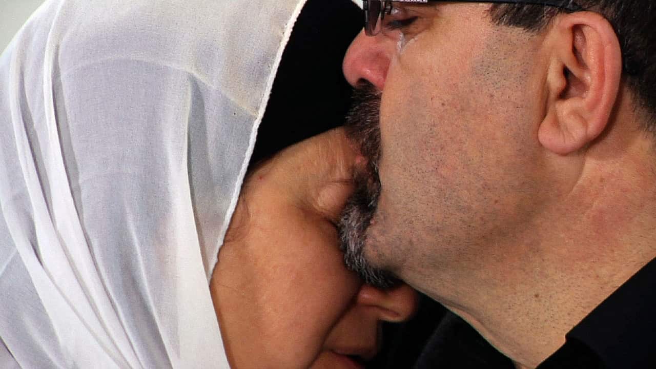Namee Barakat hugs a female relative after the death of his son, Deah, his daughter-in-law and her sister.