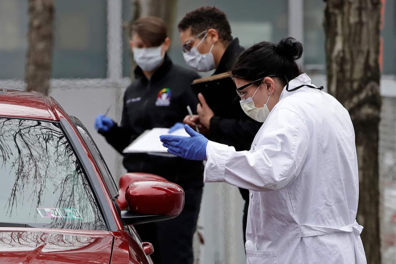 Cars line up for drive-by testing for COVID-19 in America.