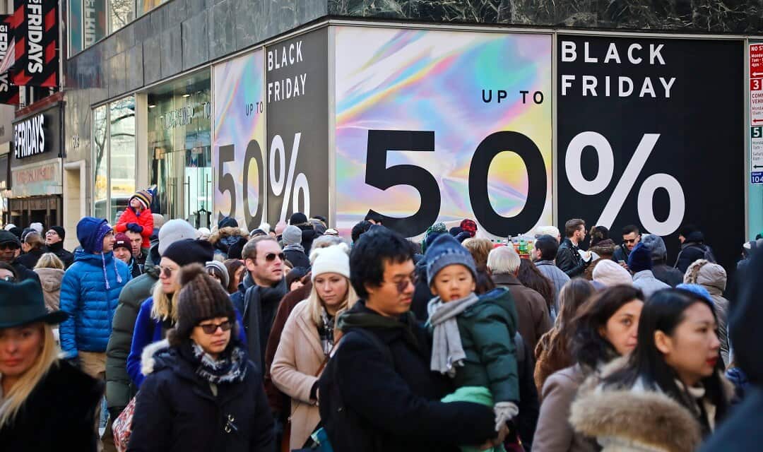 Holiday crowds outside shops promising big discounts for Black Friday.